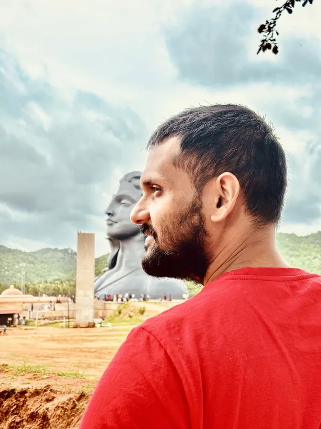 Profile of Prasenjit in front of the Adiyogi statue