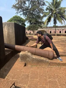 Prasenjit playfully pushing an old cannon at a fort