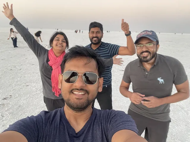 Group selfie on the white salt desert at dusk